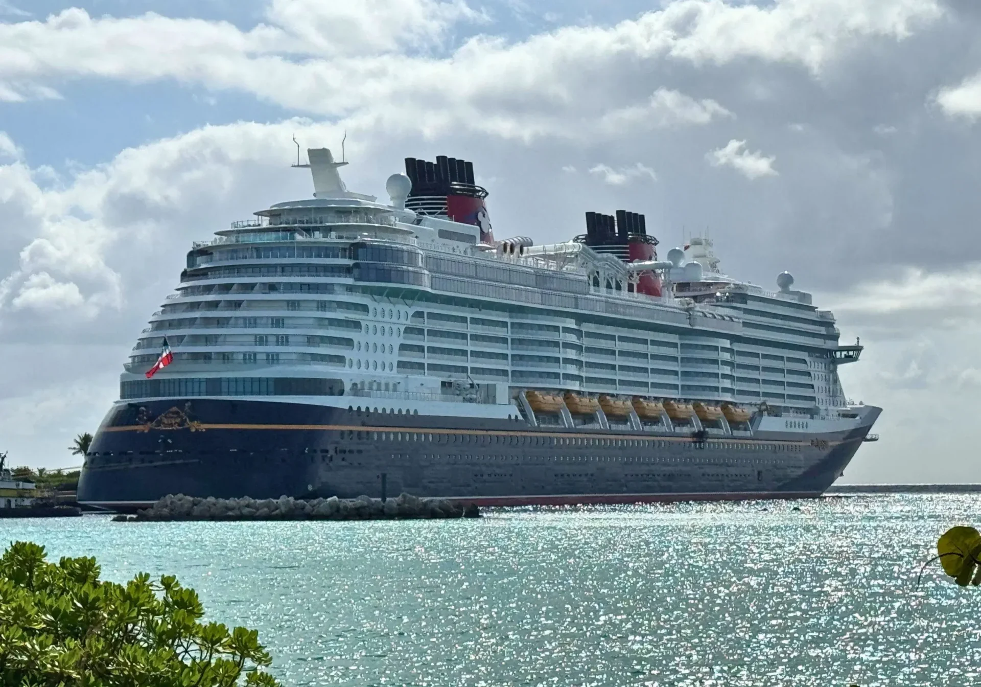 Large cruise ship docked by turquoise waters